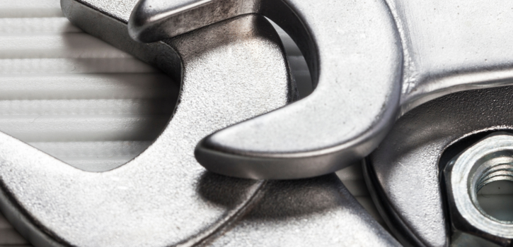 A view of several bolts and wrenches on a table