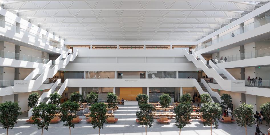 A view across the courtyard from 2nd floor showing cafe seating and treelined walkway